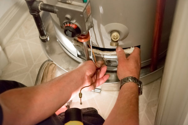 Plumber Conducting Water Heater Repair in Residential Area Boise, ID