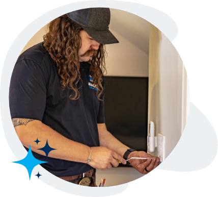 Technician checking the safety of the wires in an outlet